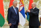 Belarus President Alexander Lukashenko presents the Order of Friendship of Peoples to Serbia President Tomislav Nikolic