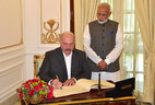 Belarus President Alexander Lukashenko leaves a message in the Book of Distinguished Guests at Hyderabad House in New Delhi