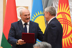 Belarus President Alexander Lukashenko presents a CSTO honorary distinction first class to Nikolai Bordyuzha