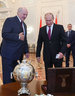 Belarus President Alexander Lukashenko and Russia President Vladimir Putin exchange presents after the session of the Supreme State Council of the Union State