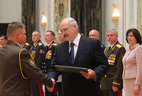 Graduate of the Command and Staff Department of the Military Academy Vladimir Bely receives a letter of commendation from the President