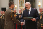 Graduate of the Military Medical Academy at the Russian Defense Ministry Vitaly Neshko receives a letter of commendation from the President