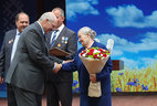Belarus President Alexander Lukashenko is presenting a letter of commendation from the President to the team of the Rodina collective farm
