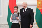Aleksandr Lukashenko presents a passport to student of Vitebsk secondary school No. 17 Kseniya Rudak