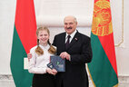 Aleksandr Lukashenko presents a passport to student of Glusk gymnasium Darya Kaminskaya