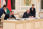 Belarus President Aleksandr Lukashenko and Egypt President Abdel Fattah el-Sisi sign bilateral documents after the talks
